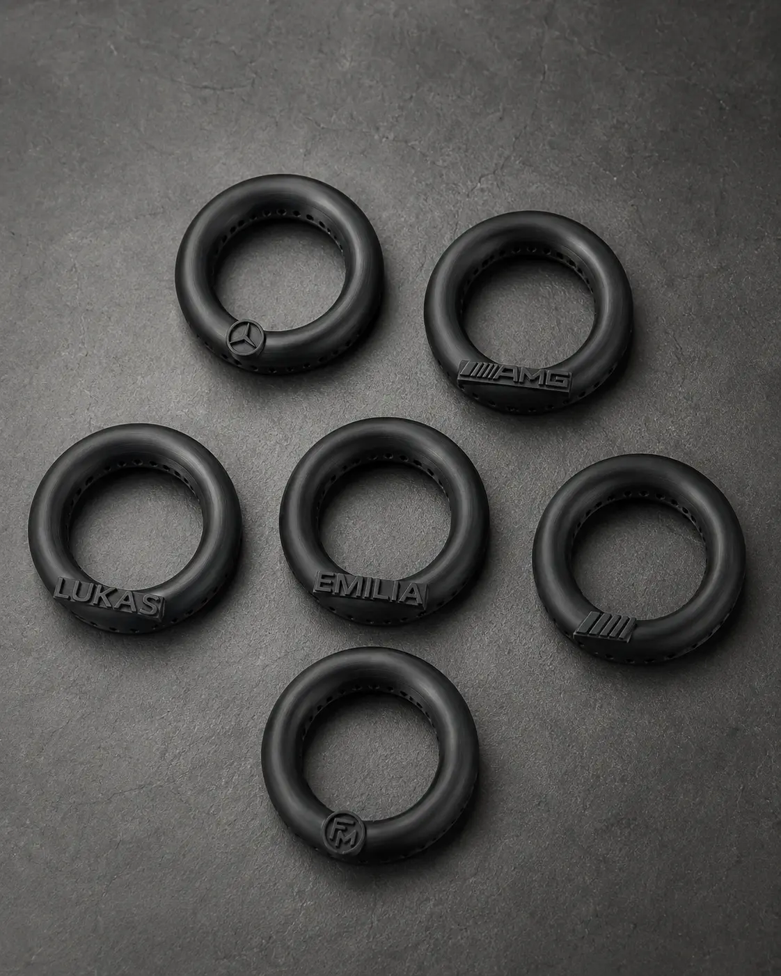 Six black diffuser customization examples, including the Floamen FM mark and raised names LUKAS and EMILIA