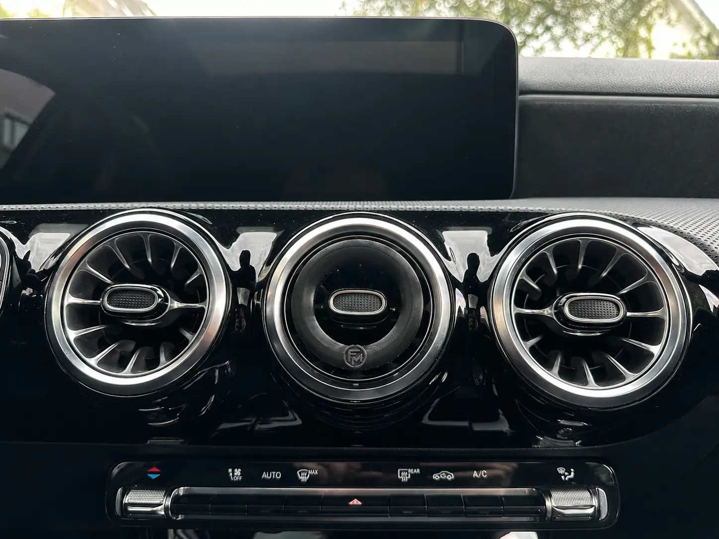 Black FM-branded Floamen diffuser fitted inside the center vent, with all three turbine vents visible