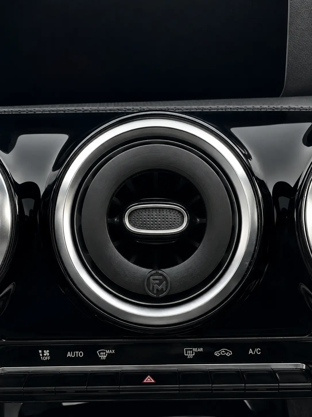 Close-up of the installed diffuser with the FM emblem at six o’clock and the original vent control accessible